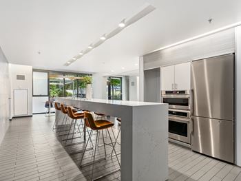 A kitchen with a large island and stainless steel appliances