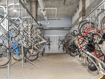 A row of bikes parked in a parking garage