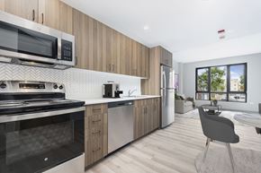 Chicago apartment for rent - a kitchen with stainless steel appliances and wooden cabinets