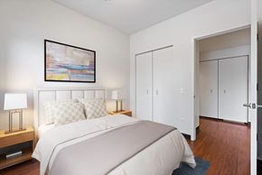 Chicago apartment for rent - a bedroom with a bed and a painting on the wall