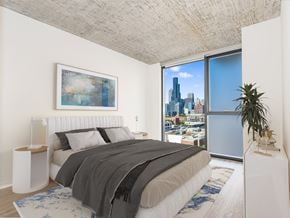 Chicago apartment for rent - a bedroom with a bed and a large window at One 333, Chicago, Illinois