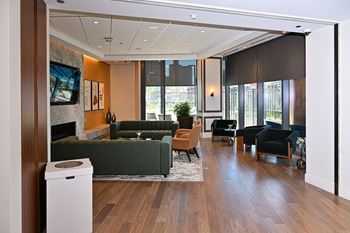 A large lobby with couches chairs and a fireplace