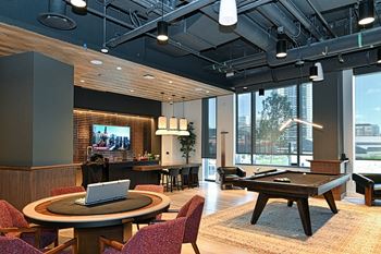 Game room complete with billiards table, poker table, and dry bar