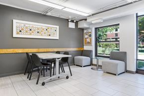 Chicago apartment for rent - a seating area with a table and chairs at Eden Commons, Chicago, IL