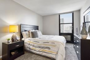 Chicago apartment for rent - a bedroom with a large bed and a large window at Eden Commons, Illinois, 60616