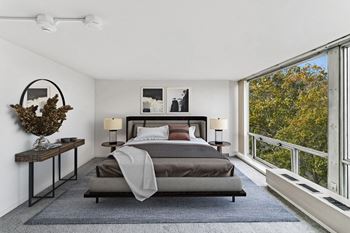 A bedroom with a bed and a large window