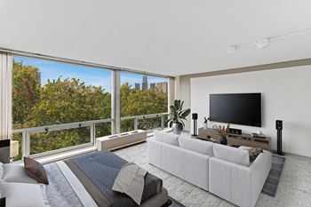 A bedroom with a large bed and a large window