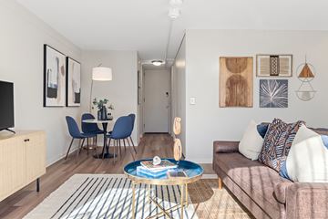 Detroit apartment for rent - a living room and dining room with a couch and a table