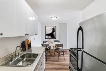 A kitchen and dining area in a 555 waverly unit