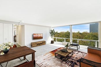 A living room with a large window and a view of the city