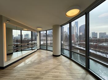 A long hallway with a view of the city outside the windows.