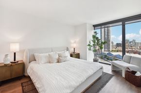 Chicago apartment for rent - a white bedroom with a large bed and a view of the city at Cassidy on Canal, Chicago, IL, 60654
