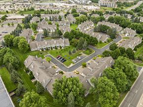 Woodbury townhouse for rent - A bird's eye view of a residential area with houses and a central park at Seasons Villas Apartments, Woodbury 55125