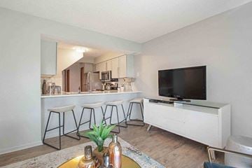 Woodbury townhouse for rent - a living room with a bar and a television