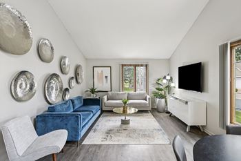 A living room with a blue couch and a television.