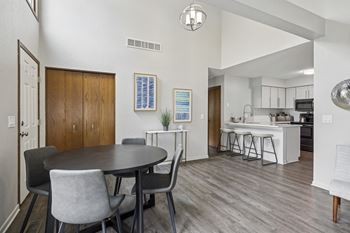 A dining room with a round table and chairs.