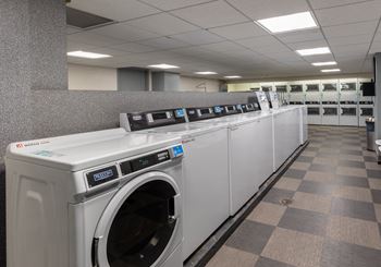 A row of washing machines in a public laundromat