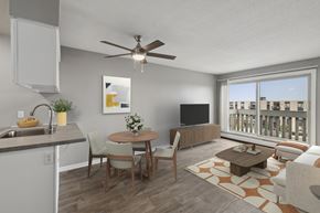 Eagan apartment for rent - Modern living room with dining area and ceiling fan at Cedarvale Highlands Apartments, Minnesota, 55122