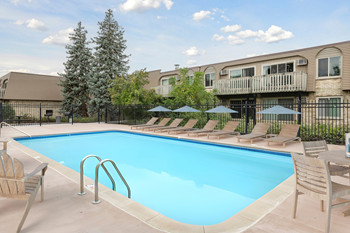 Pool deck with lounge chairs and umbrellas