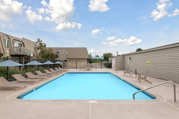 Outdoor swimming pool with lounge chairs and umbrellas
