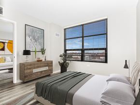 Chicago apartment for rent - a bedroom with a bed and a large window
