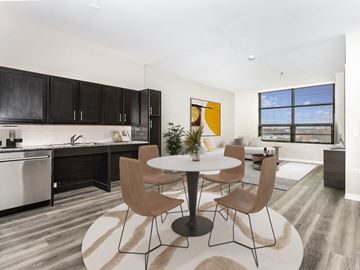 Chicago apartment for rent - a living room and kitchen with a table and chairs
