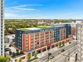 Chicago apartment for rent - a large building with a green roof on a city street
