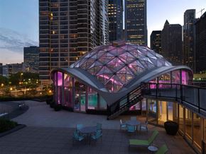 Chicago condo for rent - A modern building with a glass dome structure in the foreground.