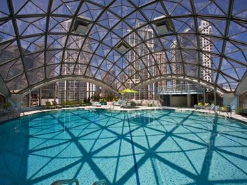 Chicago condo for rent - A large indoor pool with a glass ceiling.