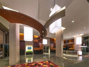 Chicago condo for rent - A large, modern hallway with a curved ceiling and a colorful rug on the floor.