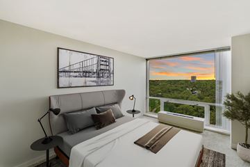 Detroit apartment for rent - A bedroom with a large bed and a picture on the wall.