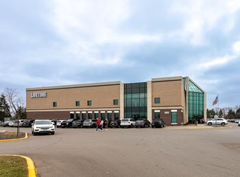 A lifetime store with a parking lot in front.