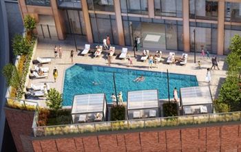 An aerial view of a swimming pool in front of a building