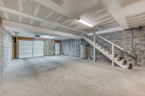 Jonesborough apartment for rent - A spacious basement with a staircase and a garage door.
