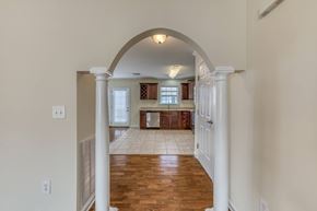 Jonesborough apartment for rent - A hallway with a white archway leading to a kitchen.