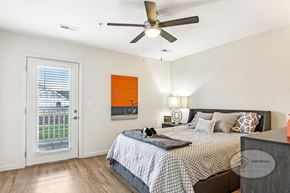 Boiling Springs townhouse for rent - A bedroom with a bed, a ceiling fan, and a glass door leading onto a balcony/patio.