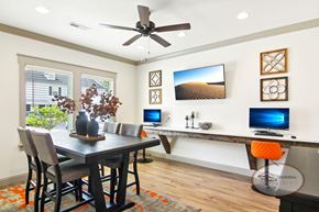 Boiling Springs townhouse for rent - The business center with computers and bar stool seating, a table and chairs, and a flat screen TV.