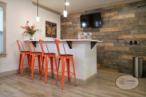 Kodak townhouse for rent - A coffee bar inside the clubhouse lounge with orange bar stool seating and a flat screen TV on a wooden accent wall.