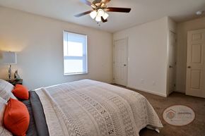 Johnson City townhouse for rent - A bedroom with a large bed and a ceiling fan.