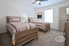 Johnson City townhouse for rent - A bedroom with two twin beds, carpet, and a ceiling fan.