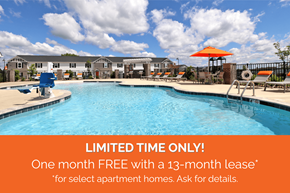 Knoxville townhouse for rent - A pool surrounded by chairs and umbrellas with a sign offering a free month with a 13-month lease for select apartment homes.