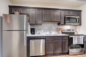 Johnson City apartment for rent - A kitchen with a stainless steel appliances and dark cabinets.