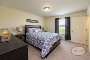 Johnson City townhouse for rent - A bedroom with a bed, nightstand, closet and window.