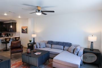 Knoxville townhouse for rent - A living room with a white couch and a brown leather chair.