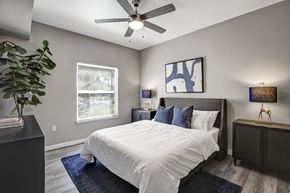 Sacramento apartment for rent - A bedroom with a large bed and a ceiling fan.