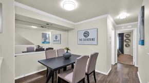 Scottsdale apartment for rent - A dining room with a table and chairs and a sign that says "The Catherine".