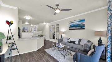 Scottsdale apartment for rent - A living room with a grey couch and a painting on the wall.