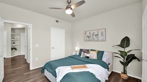 Scottsdale apartment for rent - A bedroom with a bed, a ceiling fan, and a potted plant.