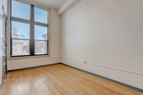 Milwaukee apartment for rent - a living room with a large window and wooden floors