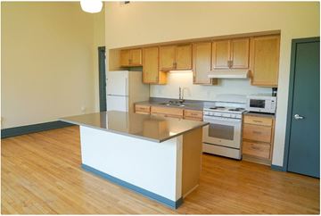 Milwaukee apartment for rent - a kitchen with wooden floors and a white counter top
